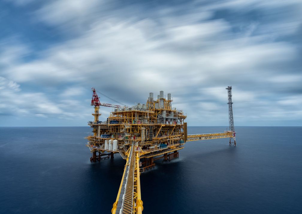 Offshore production platform under a long-exposure sky